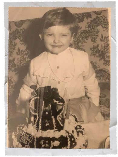 Black and white photo of a young Yoana Nin celebrating a birthday with a cake.